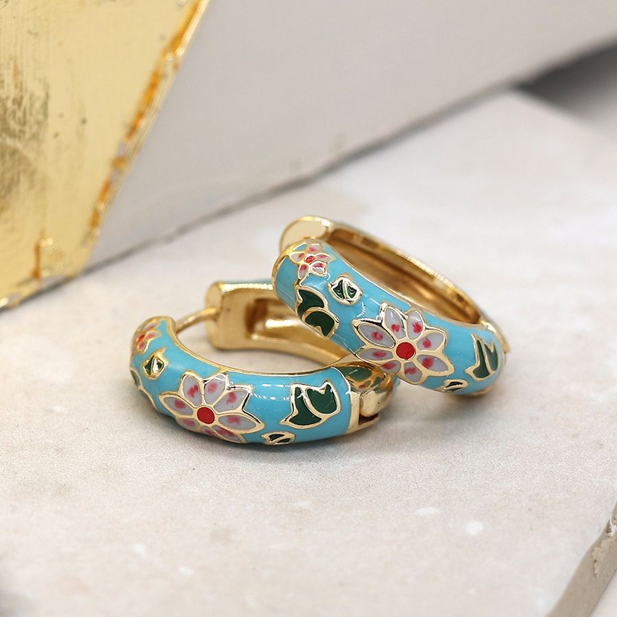 Golden hoop earrings with floral enamel